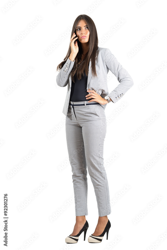Serious corporate woman talking on the phone looking away isolated Serious corporate woman talking on the phone looking away isolated