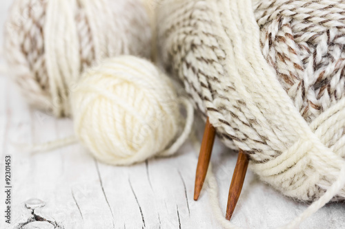 Skeins of wool yarn and knitting needles