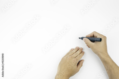 Hand holding a black marker isolated on white with copy space