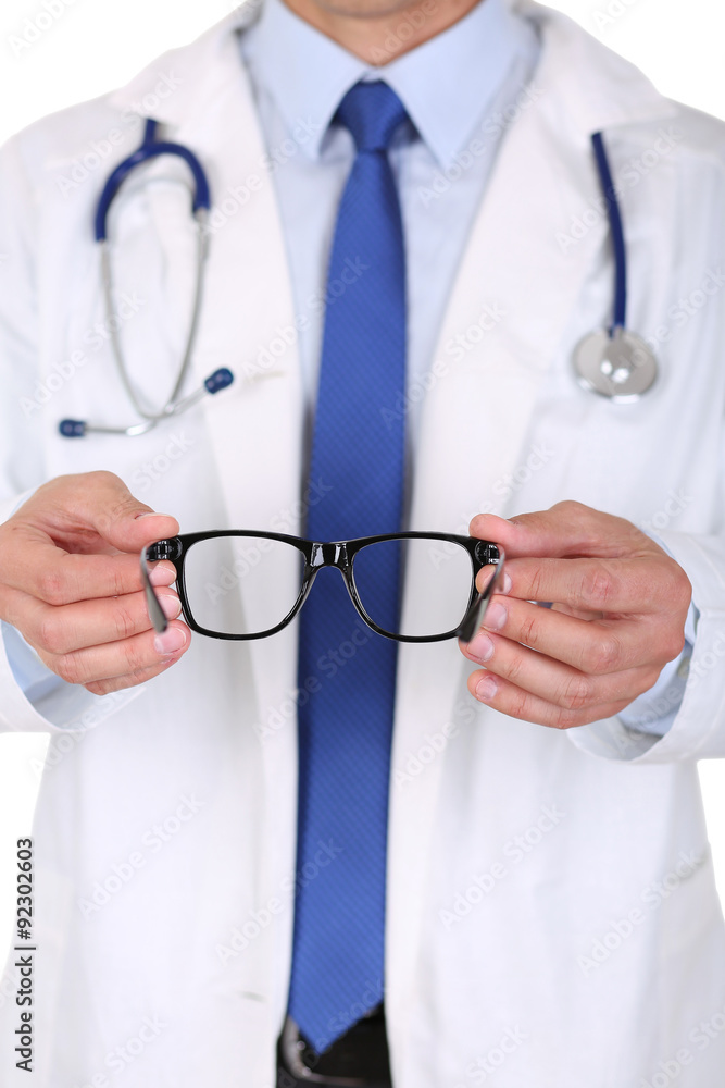 Male medicine doctor hands giving pair of black glasses to patie Male medicine doctor hands giving pair of black glasses to patie
