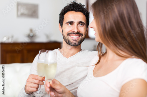 Young couple celebrating with champagne glasses
