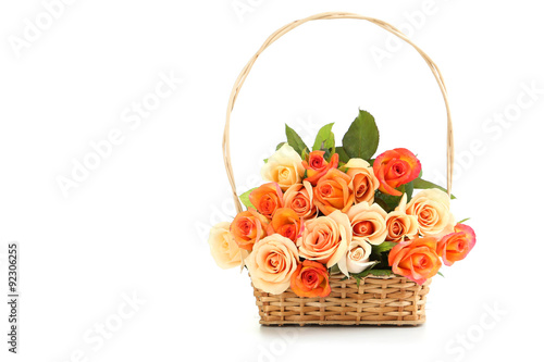 Bouquet of orange roses in basket isolated on white