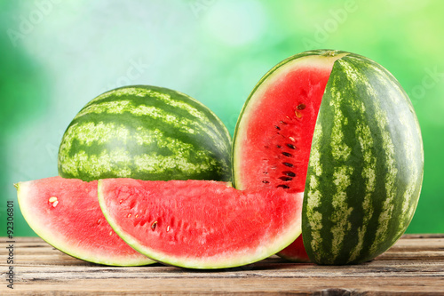 Tasty watermelon on brown wooden background photo