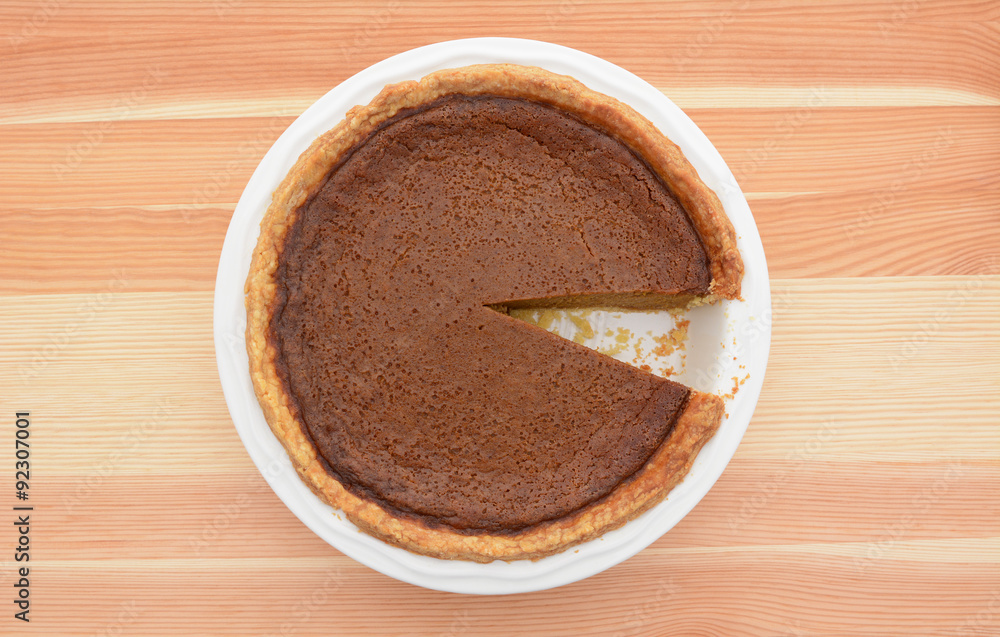 Pumpkin pie with one slice taken Pumpkin pie with one slice taken