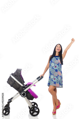 Happy mom with her baby in pram 