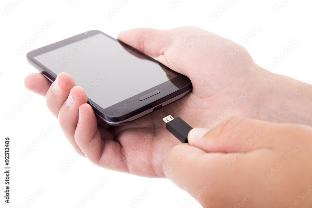smart phone with blank screen and charger in male hands isolated smart phone with blank screen and charger in male hands isolated