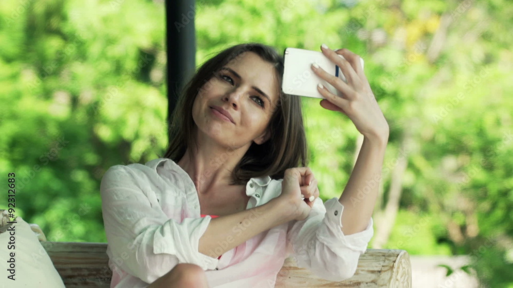 Young, pretty woman taking selfie photo with cellphone on terrace Young, pretty woman taking selfie photo with cellphone on terrace