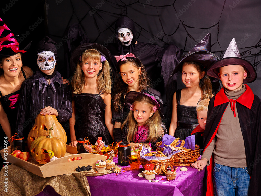 Children on Halloween party making pumpkin Children on Halloween party making pumpkin