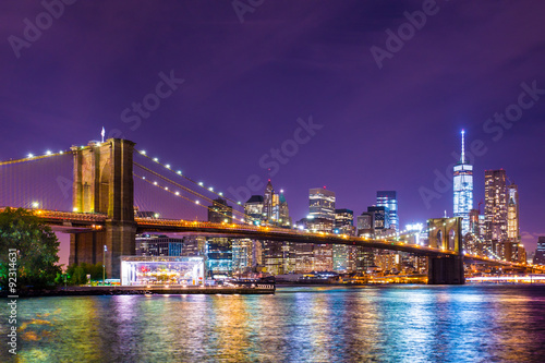 Beautiful  New York City view of the Brooklyn Bridge looking towards Manhattan at night © littleny