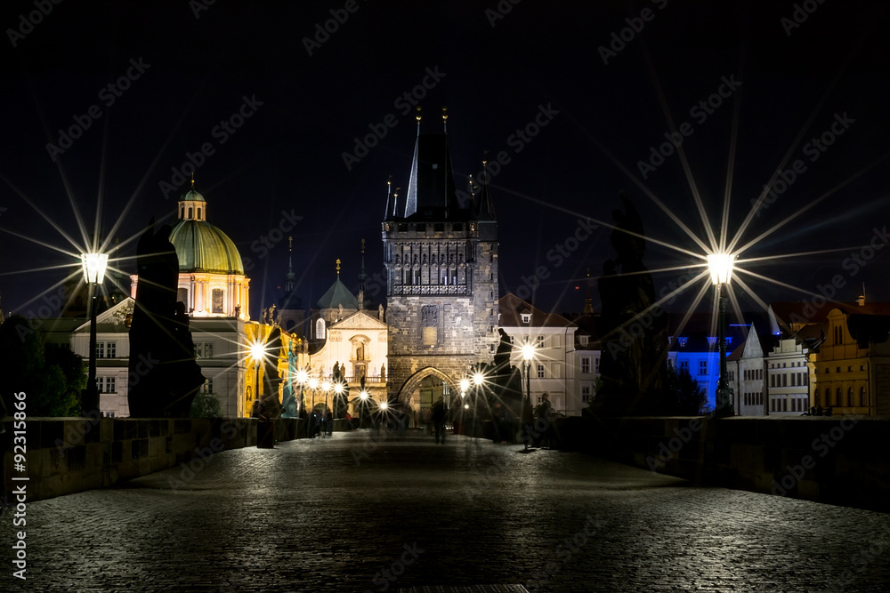 The Charles Bridge in the evening, in the light of lanterns. 
