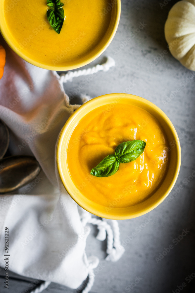 Pumpkin soup on rustic background