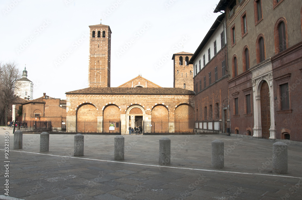 Frontal sight of the basilica and the two  bell tower of saint Ambrogio of Milan, Italy