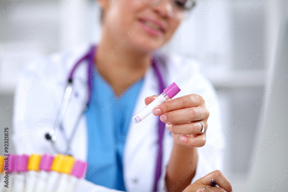 Woman researcher is surrounded by medical vials and flasks Woman researcher is surrounded by medical vials and flasks