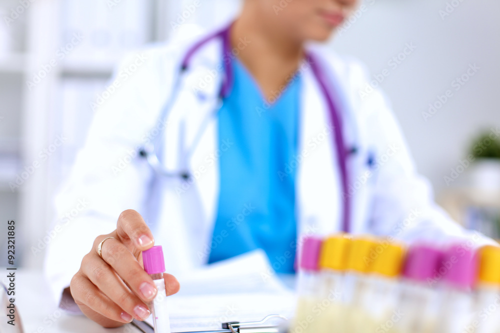 Woman researcher is surrounded by medical vials and flasks Woman researcher is surrounded by medical vials and flasks