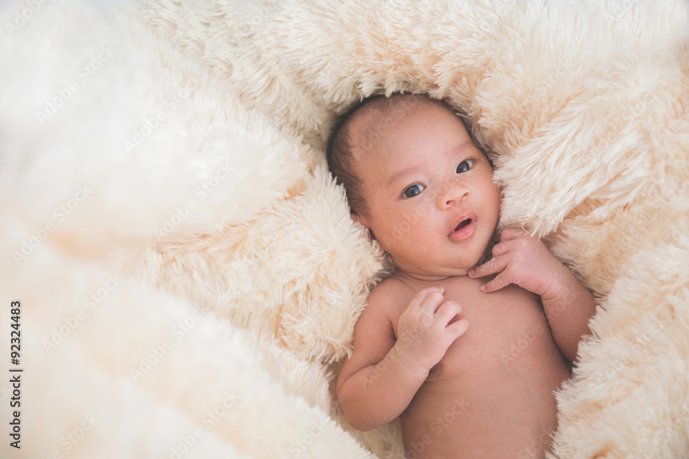 Cute baby in fur blanket, close up