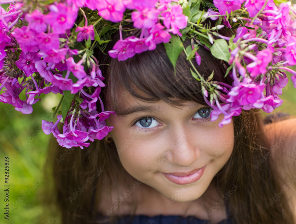 Naklejka premium Portrait of girl with wreath of flowers