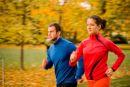Couple jogging in nature - motion blur