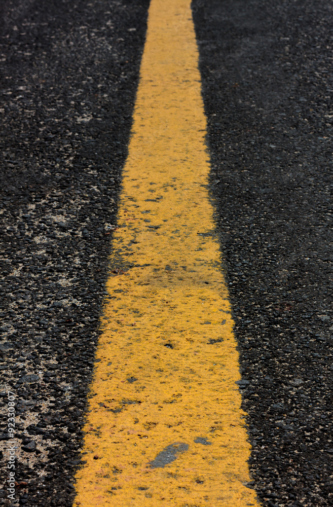 Obraz premium old yellow line on road background.