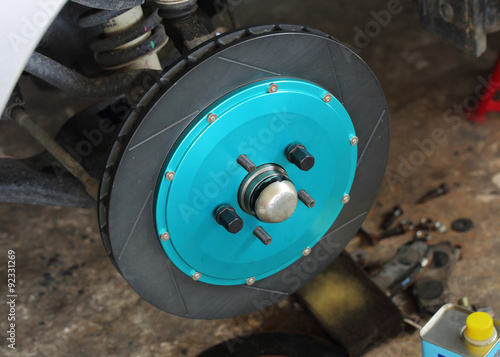 close up of blue front disc brake on car