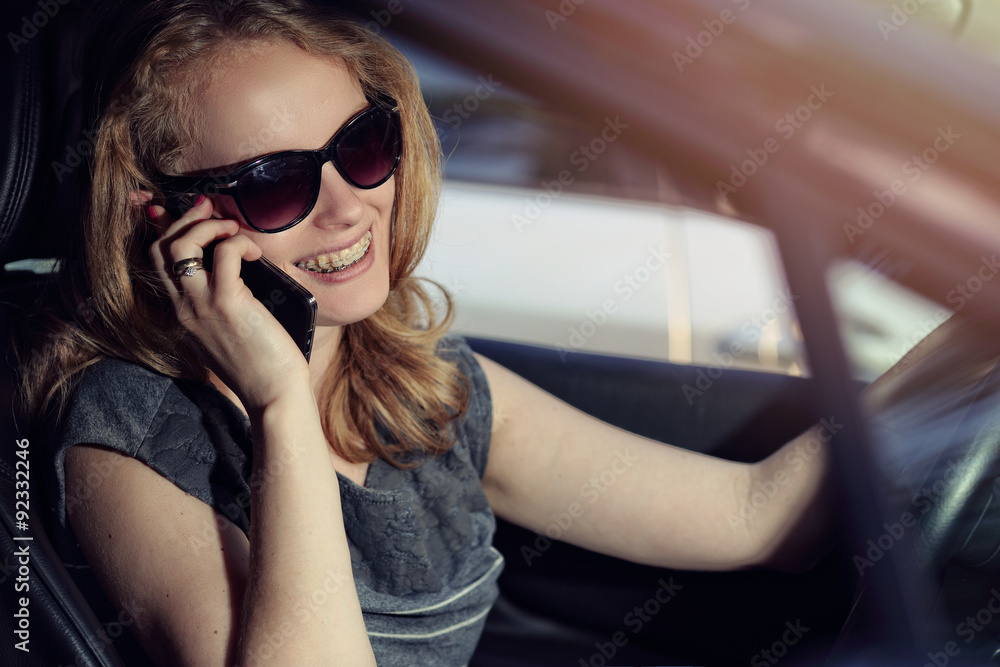 Woman talking on the phone in the car Woman talking on the phone in the car