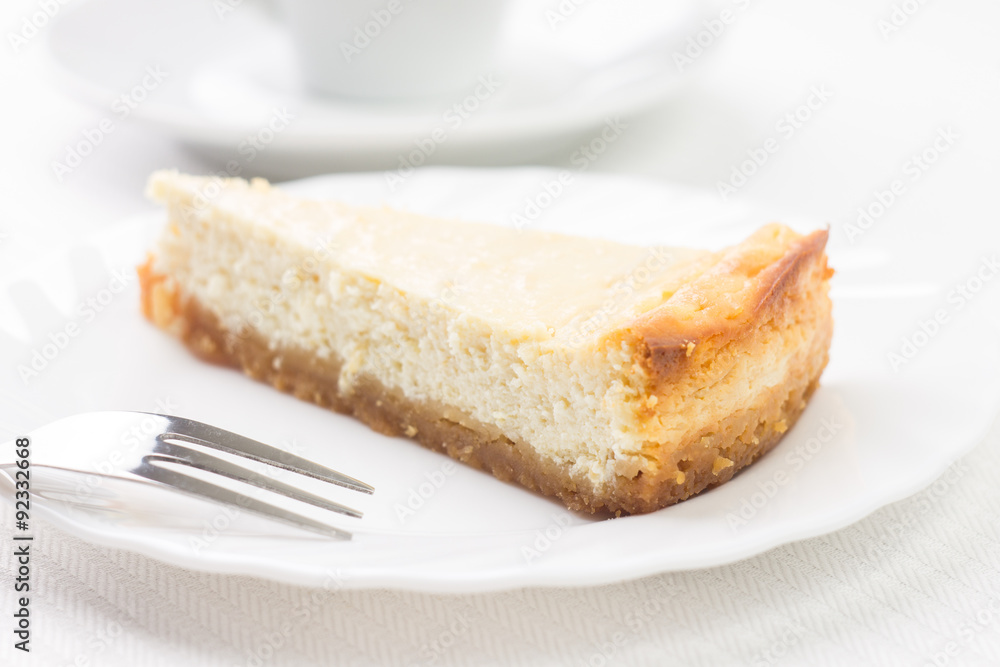 Piece of cheesecake on white plate Piece of cheesecake on white plate