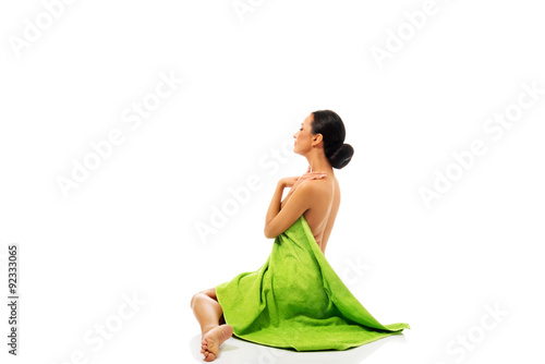 Woman sitting wrapped in towel 