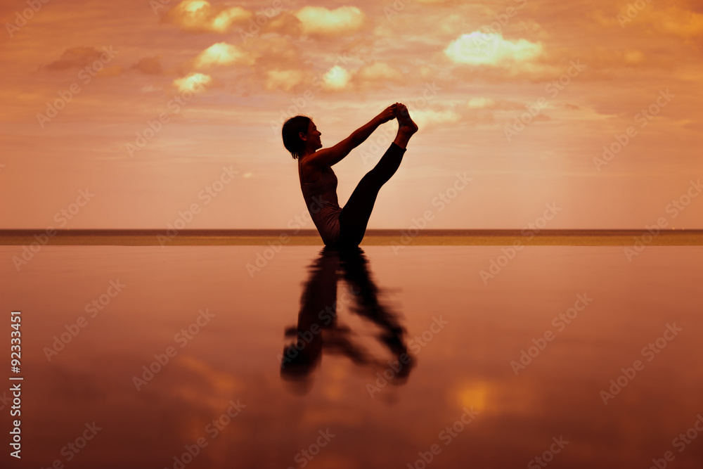 silhouette Reflextion of low lunge in Yoga pose with sunset background