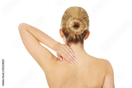Young topless woman with back pain