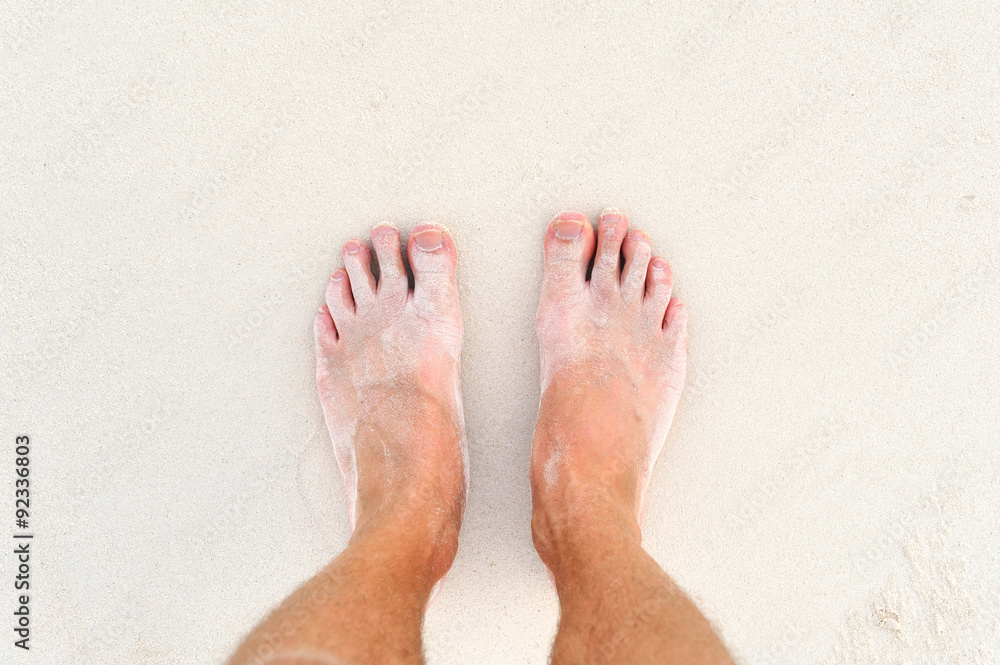 Male`s foot on sand Male`s foot on sand
