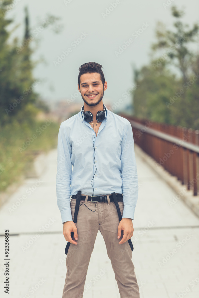 Young handsome man posing in an urban context Young handsome man posing in an urban context