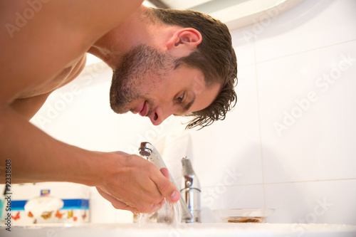 Fototapeta Naklejka Na Ścianę i Meble -  Man washes in bathroom