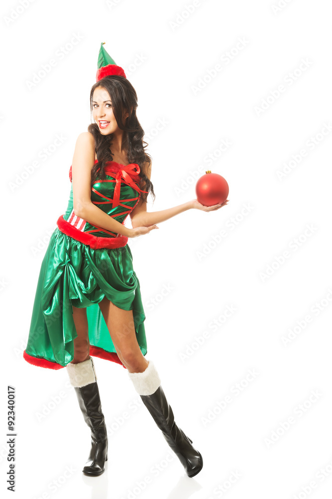 Full length woman holding christmas bubble on the left hand