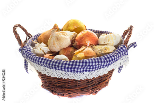 basket of garlic and onion on white background