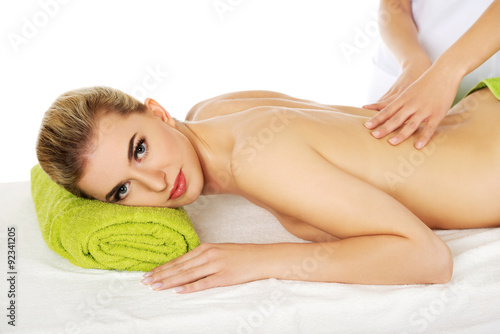 Young relaxed woman lying on a massage table and has massage.