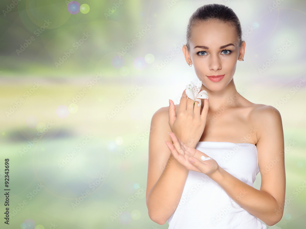 Girl holds a lily in one hand and the cream in the other Girl holds a lily in one hand and the cream in the other