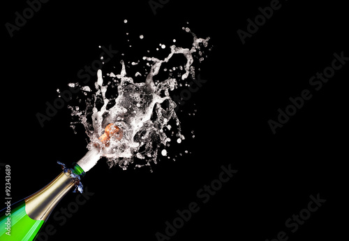  popping champagne bottle on black background. celebration, party and new year concept.