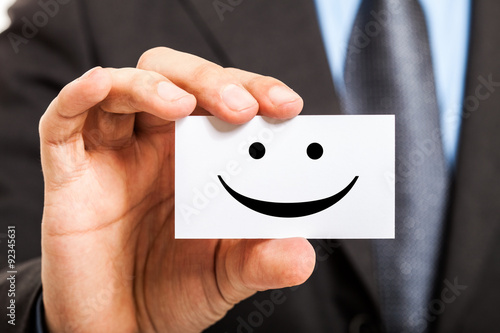 Man holding a smiling business card