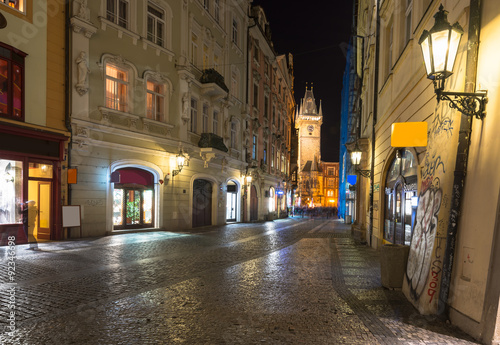 Night view of old street and Astronomical Clock Orloj in Prague. Czech Republic