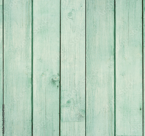 Old wooden board painted light green.