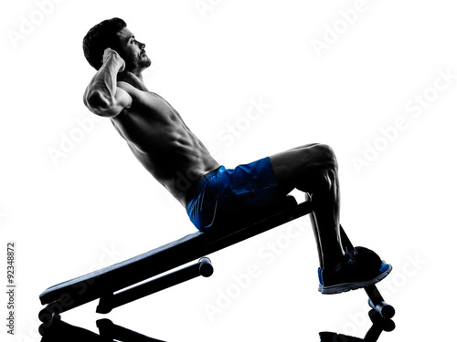 Fototapeta man exercising fitness crunches  silhouette