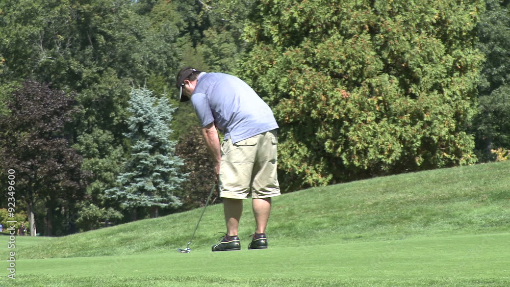 Lefty golfer putts ball Lefty golfer putts ball