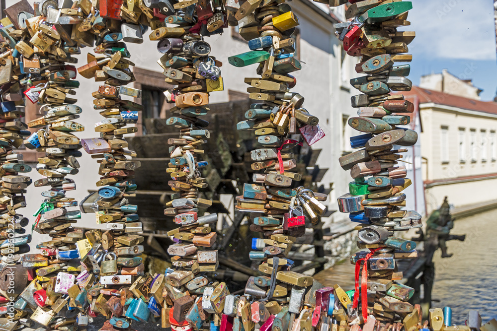 Fototapeta premium Love Locks on Fence with Certovka on background, Prague, Bohemia, Czech republic, Central Europe