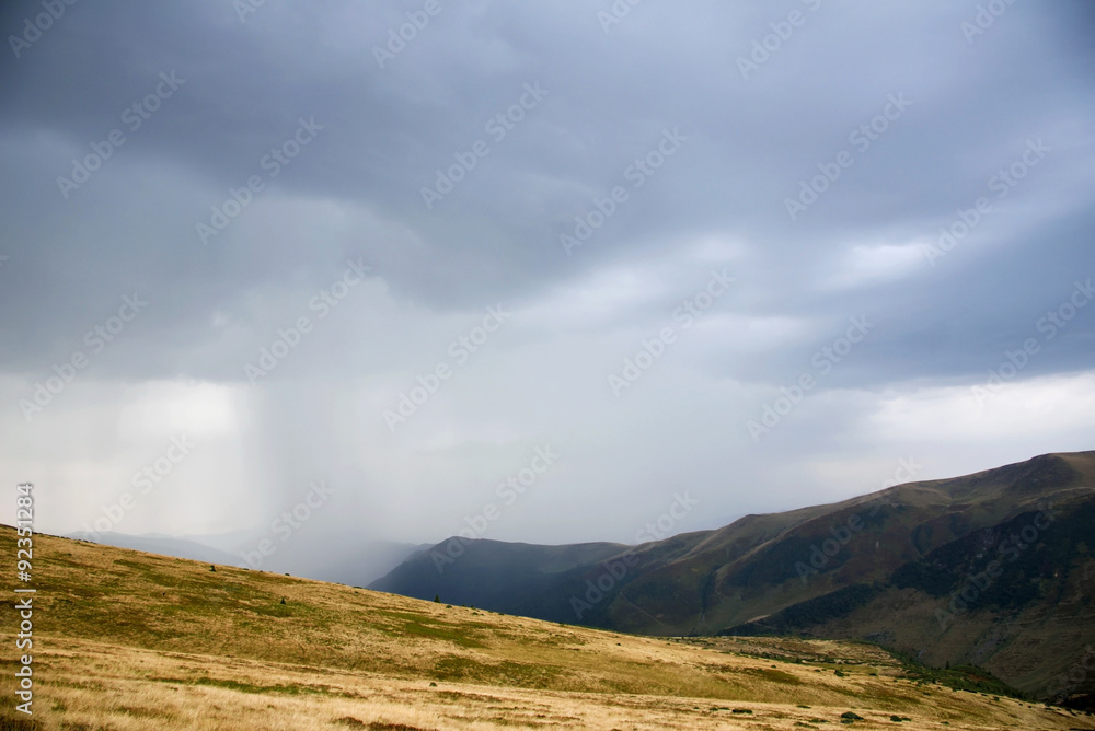 Mystical landscape with rain clouds high in the mountains. Carpa