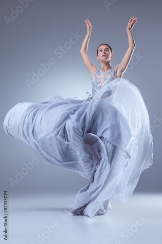 The beautiful ballerina dancing in blue long dress 