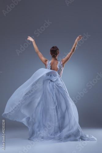 The beautiful ballerina dancing in blue long dress 