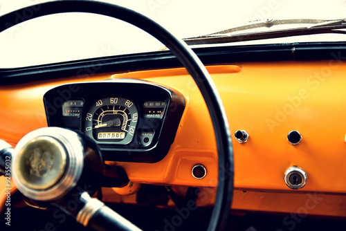 Fragment of interior retro car with speedometer, toggle switches