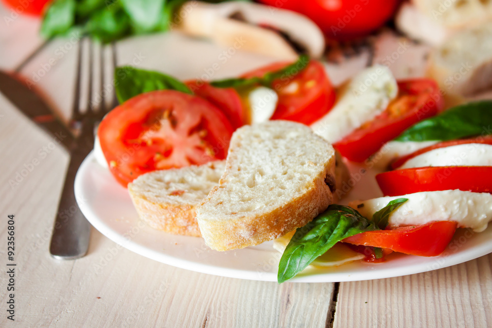 Caprese with tomatoes, mozzarella and basil Caprese with tomatoes, mozzarella and basil