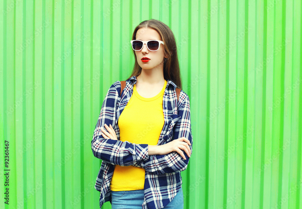 Fashion young woman in trendy casual clothes and sunglasses over