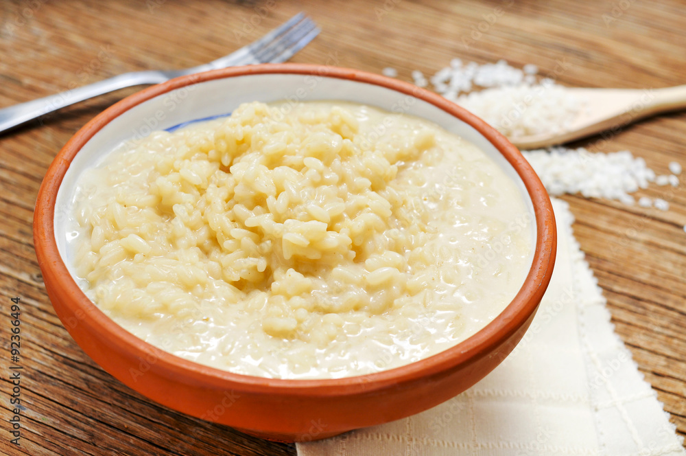 four cheese risotto on a wooden table four cheese risotto on a wooden table