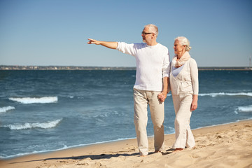 happy senior couple on summer beach